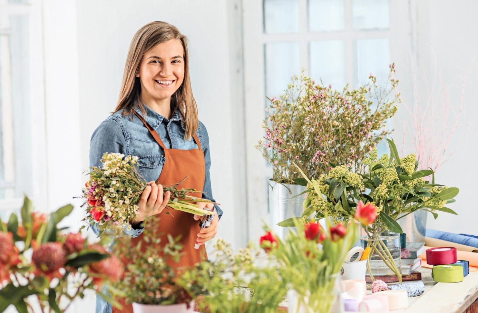 Close-up of hands arranging flowers during a live demonstration